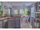 Open concept kitchen with gray cabinets, granite countertops, stainless appliances, and an eat-in kitchen area at 4348 Tillage Path, Douglasville, GA 30135