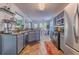 Open concept kitchen featuring tile floors, gray cabinets, and an eat-in kitchen area with natural lighting at 4348 Tillage Path, Douglasville, GA 30135