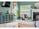 Cozy living room features a fireplace, a large window, and a well-decorated cabinet creating an inviting atmosphere at 4348 Tillage Path, Douglasville, GA 30135
