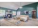 Bright living room with vaulted ceilings, fireplace, and stylish decor with lots of natural light from multiple windows at 4348 Tillage Path, Douglasville, GA 30135