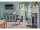 Bright and stylish living room featuring a TV, a decorative cabinet, a fireplace, and natural lighting from a window at 4348 Tillage Path, Douglasville, GA 30135