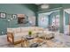 Open-concept living room with view to kitchen and dining area, featuring a large sectional couch and stylish decor at 4348 Tillage Path, Douglasville, GA 30135