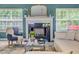 Bright living room featuring a fireplace, decorative mirror, and a cozy blue armchair, creating a warm and inviting space at 4348 Tillage Path, Douglasville, GA 30135