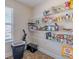 Walk-in pantry with built-in shelving, laminate floors, and storage for food and household items at 4348 Tillage Path, Douglasville, GA 30135