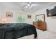 Cozy bedroom featuring plush carpet, dresser with mirror, and ceiling fan at 5161 Hermitage Dr, Powder Springs, GA 30127