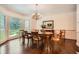 Bright dining room with hardwood floors, large windows, and elegant chandelier, ideal for formal gatherings at 5161 Hermitage Dr, Powder Springs, GA 30127