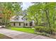 Traditional home with gray roof nestled amongst mature trees on a sprawling lot at 5161 Hermitage Dr, Powder Springs, GA 30127