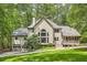 Back of house with two car garage, screened-in porch and large backyard at 5161 Hermitage Dr, Powder Springs, GA 30127