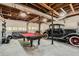 Finished garage with pool table, car and seating area at 5161 Hermitage Dr, Powder Springs, GA 30127