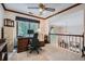 Well-lit office space with large window and view to open staircase at 5161 Hermitage Dr, Powder Springs, GA 30127
