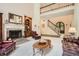 Spacious living room featuring a fireplace, built-in cabinetry, and view of the upper level at 5161 Hermitage Dr, Powder Springs, GA 30127