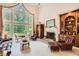 Bright living room with large windows, fireplace, and built-in shelves, offering a cozy and elegant space at 5161 Hermitage Dr, Powder Springs, GA 30127
