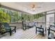 Screened porch with seating area and a view of the trees at 5161 Hermitage Dr, Powder Springs, GA 30127