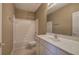 Bathroom boasts bright white vanity, mirror, and white tiled tub/shower at 580 Camry Cir, Dallas, GA 30157