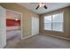 Comfortable bedroom with neutral colors and ceiling fan connects to another room with red accent wall at 580 Camry Cir, Dallas, GA 30157