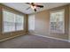 A serene bedroom is illuminated by natural light from multiple windows and features a ceiling fan at 580 Camry Cir, Dallas, GA 30157