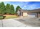 Spacious driveway leads to a well-maintained home with a two-car garage, and a neatly landscaped front yard at 580 Camry Cir, Dallas, GA 30157