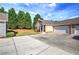 Spacious driveway leads to a well-maintained home with a two-car garage, and a neatly landscaped front yard at 580 Camry Cir, Dallas, GA 30157