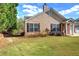 Exterior featuring well-maintained lawn, mature trees and neutral siding at 580 Camry Cir, Dallas, GA 30157