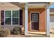 Home featuring a brick entryway, dark shutters and a well-maintained lawn at 580 Camry Cir, Dallas, GA 30157