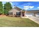 Charming home featuring a well-manicured front yard, neutral siding and an attached garage at 580 Camry Cir, Dallas, GA 30157