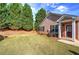 Home featuring a well-manicured lawn, and mature trees with a brick entryway at 580 Camry Cir, Dallas, GA 30157