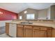 Kitchen with breakfast bar overlooking living room, standard appliances, and wooden cabinets at 580 Camry Cir, Dallas, GA 30157