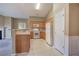 Well-lit kitchen with wooden cabinets, white appliances, and breakfast bar overlooking living area at 580 Camry Cir, Dallas, GA 30157