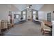 Large community room with neutral walls, tall ceilings, fireplace, lots of windows, and community tables and chairs at 580 Camry Cir, Dallas, GA 30157