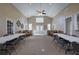 Large community room with neutral walls, tall ceilings, fireplace, lots of windows, and community tables and chairs at 580 Camry Cir, Dallas, GA 30157