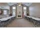 Large community room with neutral walls, tall ceilings, fireplace, lots of windows, and community tables and chairs at 580 Camry Cir, Dallas, GA 30157