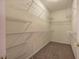 Spacious walk-in closet features carpeted floor and multiple wire shelving units for ample storage at 580 Camry Cir, Dallas, GA 30157