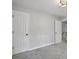 Bedroom area with neutral carpet and two entry doors at 800 Post Road Cir, Stone Mountain, GA 30088