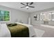 Bright bedroom featuring ceiling fan and access to ensuite bath with dual sinks at 800 Post Road Cir, Stone Mountain, GA 30088