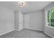 Bedroom with light grey walls features carpet and large window at 800 Post Road Cir, Stone Mountain, GA 30088