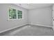 Bedroom features carpet, light grey paint and large window to exterior at 800 Post Road Cir, Stone Mountain, GA 30088
