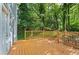 Backyard view of wood deck overlooking the lush, green backyard surrounded by trees at 800 Post Road Cir, Stone Mountain, GA 30088