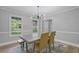 Bright dining room featuring modern light fixture, table with seating, and view of large windows at 800 Post Road Cir, Stone Mountain, GA 30088