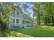 Stylish home with a well-maintained lawn, inviting porch, and mature trees enhancing its curb appeal at 800 Post Road Cir, Stone Mountain, GA 30088