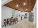 Modern kitchen featuring white cabinets, stainless steel appliances, wood ceiling, and wood floor at 800 Post Road Cir, Stone Mountain, GA 30088