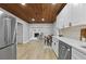 Bright kitchen with stainless steel appliances, white cabinets and countertops, and open to living area at 800 Post Road Cir, Stone Mountain, GA 30088
