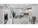 Bright living room with fireplace and open floor plan view of kitchen, with gray accent chairs at 800 Post Road Cir, Stone Mountain, GA 30088