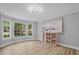 Sun-filled living room features hardwood floors, large windows, and neutral decor, creating a bright and inviting atmosphere at 800 Post Road Cir, Stone Mountain, GA 30088