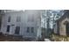 Exterior view of a house under construction with gray siding and visible framework, surrounded by trees and greenery at 1301 Lavista Ne Rd, Atlanta, GA 30324