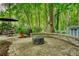 Stone patio with a firepit, manicured landscaping, a seating area and a grill at 2165 Robin Hood Trl, Cumming, GA 30040