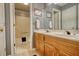 Bathroom featuring a double sink vanity, framed mirrors, and a shower-tub combination at 2165 Robin Hood Trl, Cumming, GA 30040