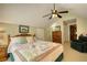 Bedroom featuring a bed with quilt, dresser and fan; perfect for relaxation and serene retreat at 2165 Robin Hood Trl, Cumming, GA 30040