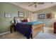 Comfortable bedroom with a wood bed frame, green walls, and decorative wall art at 2165 Robin Hood Trl, Cumming, GA 30040