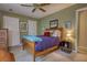 Inviting bedroom showcasing a wooden bed frame, green walls, and a cozy ambiance at 2165 Robin Hood Trl, Cumming, GA 30040