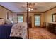 Relaxing bedroom featuring a detailed area rug, a four poster bed, and tranquil window views at 2165 Robin Hood Trl, Cumming, GA 30040